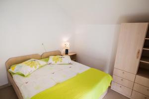 a small bedroom with a bed with a lamp on it at Beach Holiday Home Laura in Mimice