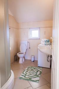a bathroom with a toilet and a sink at Beach Holiday Home Laura in Mimice