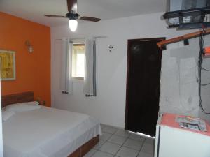 a bedroom with a bed and a window and a television at Hotel Serra De Penedo in Penedo