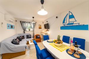a living room with a couch and a table and chairs at Family in Gradac