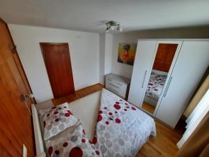 a small bedroom with a bed and a mirror at Apartmani Scripea in Škrip