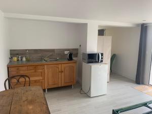 a kitchen with a sink and a refrigerator at suite junior OMAHA BEACH in Flers