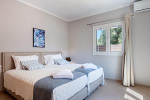 a bedroom with a large bed with two pillows at Waterway Luxury Residence-Apartment 1 in Kefallonia