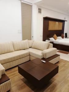 a living room with a couch and a bed at Oak Residencies in Kiribathgoda