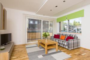 a living room with a couch and a table at Apart Simon Seefeld in Seefeld in Tirol