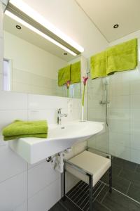 a white bathroom with a sink and a mirror at Apart Simon Seefeld in Seefeld in Tirol