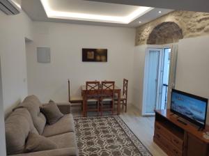 a living room with a couch and a tv at ISAMAR Apartamentos in Vejer de la Frontera