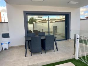 a black table and chairs on a patio at Loft Deluxe Raquel in Conil de la Frontera