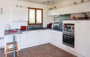 CruzyにあるAmazing Home In Cruzyの白いキャビネットとコンロ付きオーブンを備えたキッチン