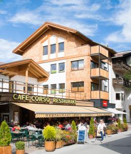 a building with a cafe crore restaurant in front of it at Apart Simon Seefeld in Seefeld in Tirol