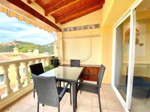 a patio with a table and chairs on a balcony at Encantador alojamiento en Altea Hills in Altea