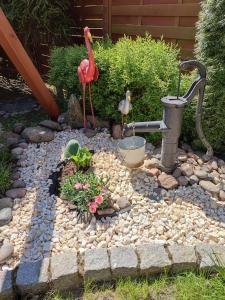a garden with a faucet and two flamingos in a yard at Willa WiK in Rewal