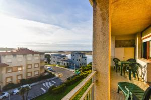 balkon z krzesłami i widokiem na ulicę w obiekcie Apartamento con vistas al mar-Ola del atardecer w mieście Mogro