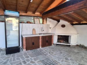 a kitchen with a pizza oven in a room at Къща за гости Катлея in Tsarevo