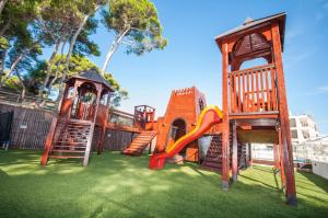 a playground with a slide and a play structure at Hotel Mirta in Božava