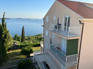a building with stairs and a view of the water at Dom Lovrenko in Mlini