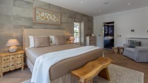 a bedroom with a large bed and a living room at Portuguese mansion close to marina, golf and beach. in Vilamoura +42 photos