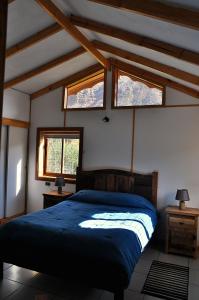 Un pat sau paturi într-o cameră la Cabañas La Calchona