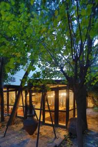 a building with a tree and a swing at Hotel Kalehan in Selçuk