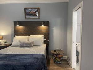 a bedroom with a large bed with a wooden headboard at Cades Cove Paradise SoftTub Spa Fireplace in Townsend