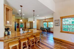 a kitchen with a large island with bar stools at Iyer Lakehouse in Bass Lake