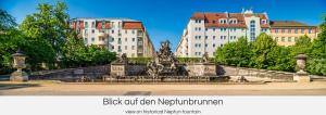 une fontaine dans un parc avec des bâtiments en arrière-plan dans l'établissement "Neptunblick"- Nähe Altstadt - Ruhig - Klinikum, à Dresde