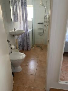 a bathroom with a toilet and a sink at Cozy house in central Lysekil, 4-6 beds in Lysekil +9 photos