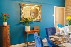 a dining room with a table and a mirror at The Anchorage - sea views and beach on doorstep in Amble