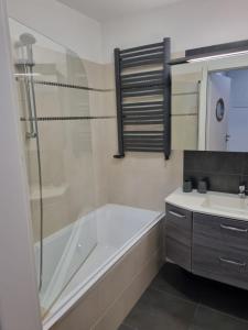 a bathroom with a shower and a tub and a sink at Playa Baltis Międzyzdroje Apartament Katharina in Międzyzdroje +65 photos