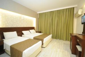 Postel nebo postele na pokoji v ubytování Palmea Hotel