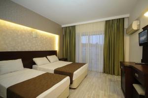 Postel nebo postele na pokoji v ubytování Palmea Hotel