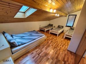 a bedroom with a large bed and a couch in a room at Rooms pr zajčku in Tolmin