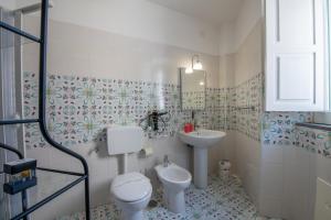 a bathroom with a toilet and a sink at Villa Lery - Azzurra Home in Agropoli