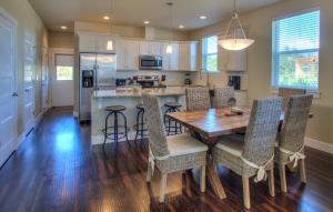 a kitchen and dining room with a wooden table and chairs at Salty Paws - Oyhut Bay Seaside Village in Ocean Shores