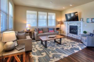 a living room with a couch and a fireplace at Salty Paws - Oyhut Bay Seaside Village in Ocean Shores