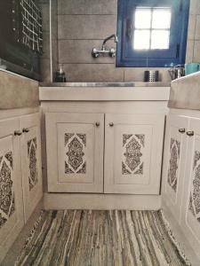 a bathroom with a sink and a counter top at Nikolakis traditional house in the village. in Kamari