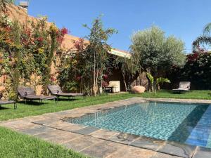 a swimming pool in the middle of a yard at VILLA ALAKASA in Amezrou