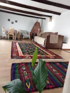 a living room with a rug on the floor at Casuta din Deal in Vaideeni