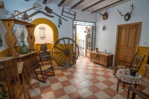 a room with a spinning wheel and chairs in it at APAR. SIERRAGUADALQUIVIR in Quesada