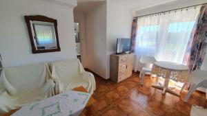 a living room with a couch and a table and a television at Holiday home in Siofok - Balaton 19917 in Siófok