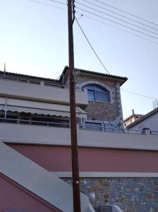 a building with a window on top of it at Golden Sunrise - Nikos Home in Gythio