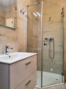 a bathroom with a sink and a shower at Apartament Ohar Downtown in Elblag