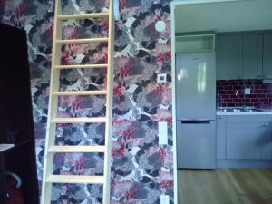 a kitchen with a wall with a floral wallpaper at Attefallshus byggt 2019 in Helsingborg