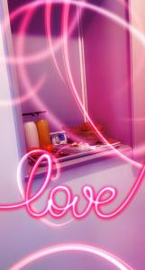 a neon sign that says love on a shelf at Adorable Guest House avec balnéo et piscine in Olonne-sur-Mer