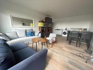 a living room with a couch and a table at The ROOF - LILLE GRAND PALAIS in Lille