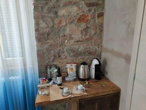 un tavolo in legno con una macchinetta del caffè sopra di Il Pozzo di Santa Zita a Lucca