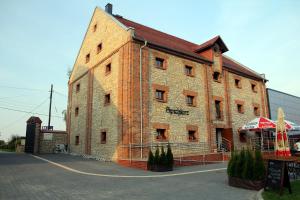 a large brick building with a tent in front of it at Noclegi Złota Podkowa in Olszowa +21 photos