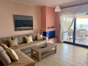 a living room with a couch and a table at Villa Porto Thassos in Limenas