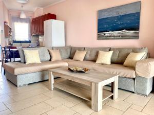 a living room with a couch and a coffee table at Villa Porto Thassos in Limenas