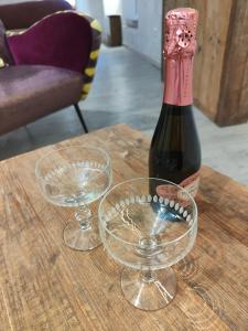 una bottiglia di vino e due bicchieri su un tavolo di Il Pozzo di Santa Zita a Lucca